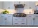 Kitchen area featuring stainless steel range, white cabinets and stone backsplash at 4503 Atley Woods Se Dr, Atlanta, GA 30339