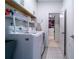 Convenient laundry room featuring modern washer and dryer, storage cabinets, and stylish tiled floors at 4503 Atley Woods Se Dr, Atlanta, GA 30339