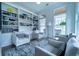 Comfortable living room with custom bookshelves, large windows, and ample seating, perfect for relaxation at 4503 Atley Woods Se Dr, Atlanta, GA 30339