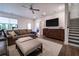 Cozy living space with comfortable leather sofas, TV, a plush rug, leading to a bright outdoors at 4503 Atley Woods Se Dr, Atlanta, GA 30339