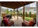 Covered patio featuring ample seating, a stone paver floor, and views of the landscaped backyard at 4503 Atley Woods Se Dr, Atlanta, GA 30339