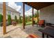 Cozy covered patio with stone pavers, comfortable seating, and a serene view of the landscaped backyard at 4503 Atley Woods Se Dr, Atlanta, GA 30339