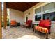 Inviting covered patio features stone flooring, comfortable seating, and a view of the landscaped backyard at 4503 Atley Woods Se Dr, Atlanta, GA 30339