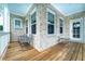 Charming covered porch with brick accents, wood flooring, seating, and natural light at 4503 Atley Woods Se Dr, Atlanta, GA 30339