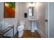 Stylish powder room with wood flooring, a pedestal sink, and modern fixtures at 4503 Atley Woods Se Dr, Atlanta, GA 30339