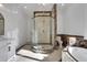 Elegant bathroom featuring a glass shower, large soaking tub, and marble accents at 821 Camden Park Ct, Atlanta, GA 30342