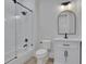 Bathroom showcases a vanity with black cabinets, round mirror, and a glass-enclosed shower at 821 Camden Park Ct, Atlanta, GA 30342