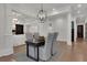 Open-concept dining area with hardwood floors, modern lighting, and access to the living area at 821 Camden Park Ct, Atlanta, GA 30342