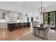 Bright kitchen featuring a large island with seating and a view of the adjacent dining and living area at 821 Camden Park Ct, Atlanta, GA 30342