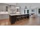 Modern kitchen with a spacious island, pendant lighting, and a view into an adjacent sitting room at 821 Camden Park Ct, Atlanta, GA 30342