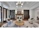 Elegant living room showcasing built-in cabinetry, a fireplace, and refined decor at 821 Camden Park Ct, Atlanta, GA 30342
