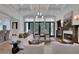 Bright, elegant living room with coffered ceilings, fireplace, and large windows offering outdoor views at 821 Camden Park Ct, Atlanta, GA 30342