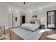 Spacious primary bedroom with tray ceilings, recessed lighting, and a door to the outside at 821 Camden Park Ct, Atlanta, GA 30342