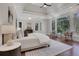 Spacious main bedroom features tray ceilings, large windows, hardwood floors, and neutral decor at 821 Camden Park Ct, Atlanta, GA 30342