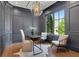 Home office features paneled walls, stylish lighting, and a large window overlooking green landscaping at 821 Camden Park Ct, Atlanta, GA 30342