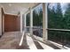 Covered porch with stone flooring and wrought iron railings, overlooking a private backyard at 821 Camden Park Ct, Atlanta, GA 30342
