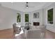 Cozy sitting room with a fireplace, large windows, and comfortable seating at 821 Camden Park Ct, Atlanta, GA 30342