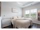 Bedroom features carpetless flooring, neutral decor, and sunlit windows, creating a cozy and inviting retreat at 135 Climbing Ivy Cir, Fayetteville, GA 30214
