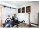 Well-lit exercise room with workout equipment, motivational artwork, and sliding barn door at 135 Climbing Ivy Cir, Fayetteville, GA 30214