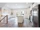 Bright kitchen boasts stainless appliances, white cabinets, gray flooring, and a central island with a breakfast bar at 135 Climbing Ivy Cir, Fayetteville, GA 30214