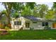 Charming home showcasing a lush green backyard, a fire pit, and fresh landscaping at 135 Martha Ne Ave, Atlanta, GA 30317