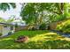 Backyard features a well-maintained lawn, wooden fence, and a stone fire pit, perfect for outdoor entertaining at 135 Martha Ne Ave, Atlanta, GA 30317