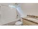 Bathroom featuring a tub and shower combination with tile surround, granite countertop, and single sink vanity at 135 Martha Ne Ave, Atlanta, GA 30317