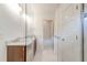 Bathroom with marble floors, double sink vanity, and glass shower at 135 Martha Ne Ave, Atlanta, GA 30317