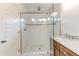 Bright bathroom featuring a glass-enclosed shower and a double sink vanity with marble countertops at 135 Martha Ne Ave, Atlanta, GA 30317