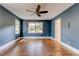 This bedroom has two windows, blue walls, hardwood floors, and a ceiling fan at 135 Martha Ne Ave, Atlanta, GA 30317