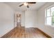 Bedroom showcasing hardwood floors, ceiling fan, one window letting in natural light, and two doors at 135 Martha Ne Ave, Atlanta, GA 30317