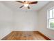 Bedroom showcasing hardwood floors, ceiling fan, one window letting in natural light, and crisp white trim at 135 Martha Ne Ave, Atlanta, GA 30317