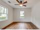 Bedroom showcasing hardwood floors, ceiling fan, two windows letting in natural light, and crisp white trim at 135 Martha Ne Ave, Atlanta, GA 30317