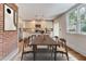 Dining room with hardwood floors, natural lighting, and view into updated kitchen at 135 Martha Ne Ave, Atlanta, GA 30317