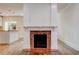 Bright living room featuring a white mantle fireplace with red brick surround and hardwood floors at 135 Martha Ne Ave, Atlanta, GA 30317