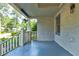 Beautiful front porch featuring neutral colors, a hanging plant, and painted brick at 135 Martha Ne Ave, Atlanta, GA 30317