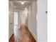 Hallway features hardwood flooring, white trim, and multiple access points to rooms at 135 Martha Ne Ave, Atlanta, GA 30317