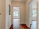 Hallway with hardwood floors leading to rooms with windows at 135 Martha Ne Ave, Atlanta, GA 30317