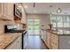 Modern kitchen with stainless steel appliances, granite counters, and a sliding glass door to the backyard at 135 Martha Ne Ave, Atlanta, GA 30317