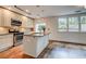 Bright kitchen features stainless steel appliances, granite counters, and hardwood floors at 135 Martha Ne Ave, Atlanta, GA 30317