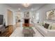 Staged living room with hardwood floors, fireplace, and view into kitchen at 135 Martha Ne Ave, Atlanta, GA 30317