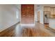 Spacious living room with hardwood floors and a view into kitchen with brick wall at 135 Martha Ne Ave, Atlanta, GA 30317