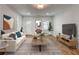 Staged living room featuring hardwood floors, neutral decor, and ample natural light at 135 Martha Ne Ave, Atlanta, GA 30317