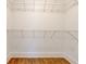 Walk-in closet with wood flooring and metal racks for storage at 135 Martha Ne Ave, Atlanta, GA 30317