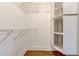 White walk-in closet with wood flooring, metal hanging racks and a built-in storage unit at 135 Martha Ne Ave, Atlanta, GA 30317