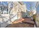 Backyard featuring a wooden deck, access door, and a white picket fence for privacy and charm at 320 Harden St, Atlanta, GA 30312