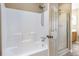 Bathroom with a white tub, shower head, and a glass door shower to the left at 320 Harden St, Atlanta, GA 30312