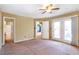 Bright bedroom featuring a ceiling fan and door to outdoor space at 320 Harden St, Atlanta, GA 30312