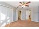 Bedroom with large closets, ceiling fan, and neutral carpeting at 320 Harden St, Atlanta, GA 30312