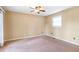 Spacious bedroom with a ceiling fan, natural light, and neutral carpeting at 320 Harden St, Atlanta, GA 30312